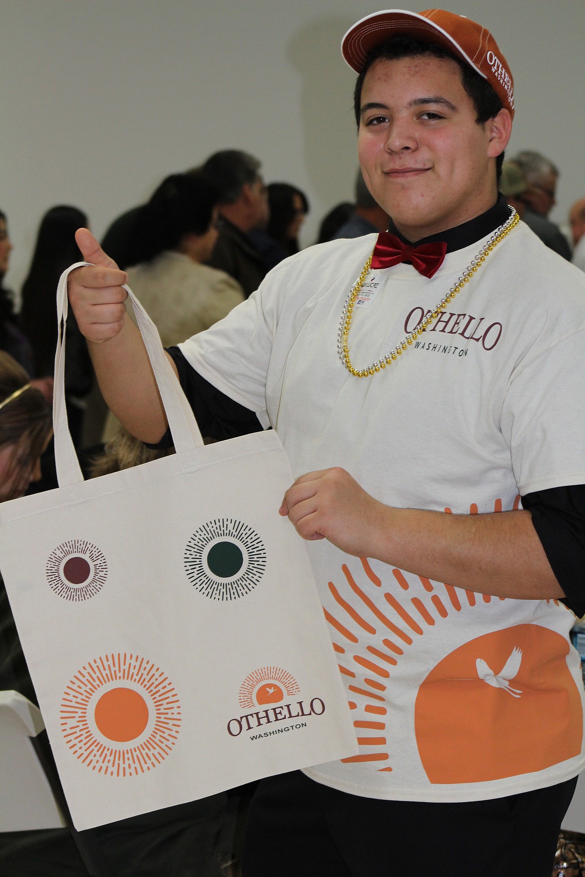 Chanet Stevenson/The Sun Tribune - Palani Barragan models the new swag with the city of Othello's brand new logo and color scheme during the 50th Annual Greater Othello Chamber Awards Banquet and Raffle last Friday.