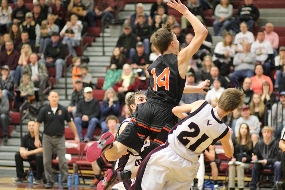 Plains Horsemen (#14 in black) Kyle Weeks makes a move aginst two Manhattan Christan players.