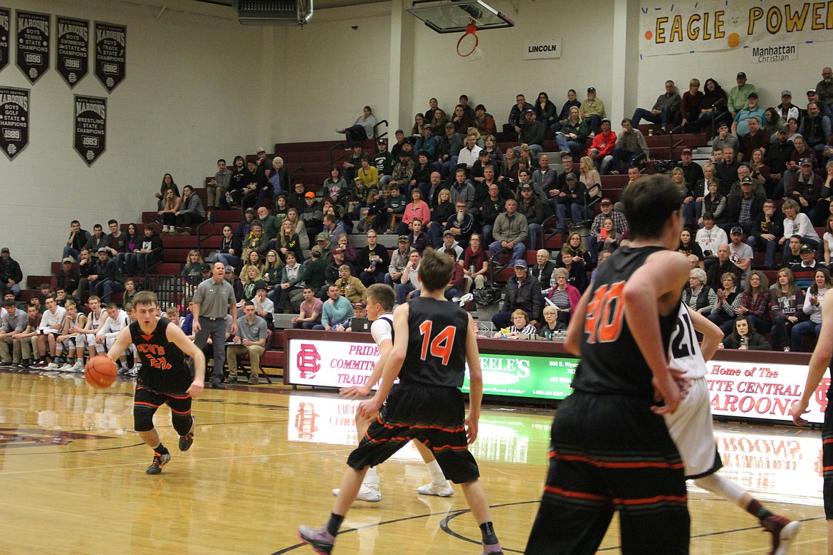Alec Cole (#22 in black) moves down the court against Manhattan Christian.