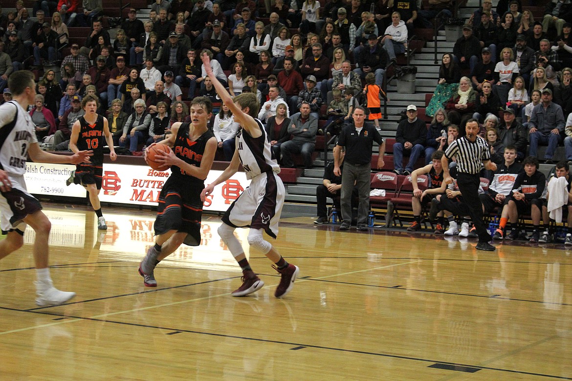 Plains Horsemen (#10 Ryan Ovitt) and a team member move th ball against Manhattan Christian during the Divisionals game.