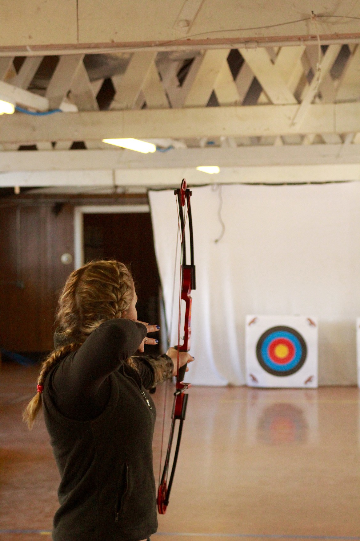 TARA LEE Ryan releases an arrow from the bow and remains in the classic archer form. (Douglas Wilks photos/Clark Fork Valley Press)