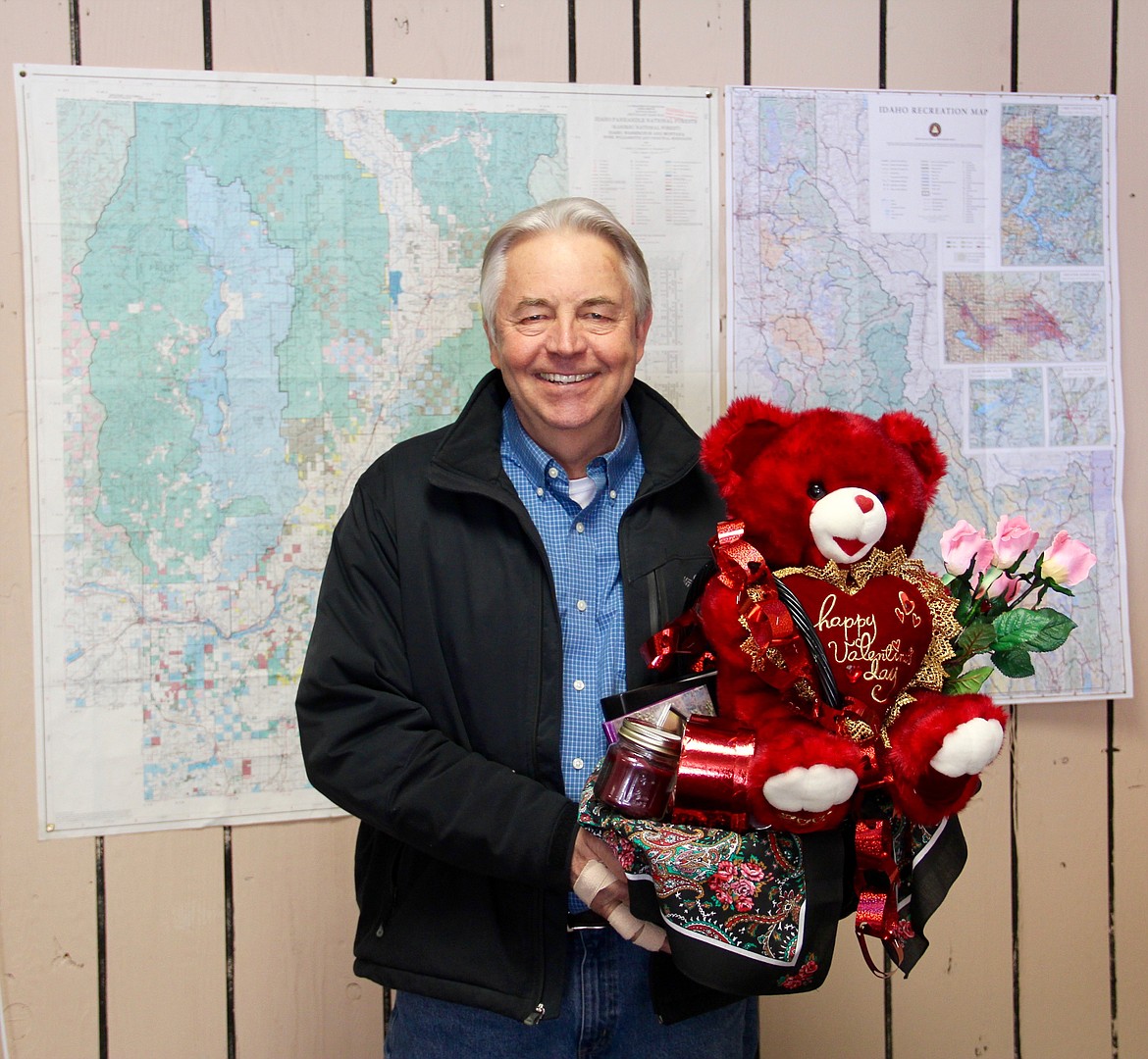 &#151;Photo by DAC COLLINS
Joe Farrell, who works as a realtor at Pace Kerby in downtown Bonners Ferry, poses with a Valentine's Day-themed basket that he won in this year's Friends of the Restorium's Valentine's Day Raffle.