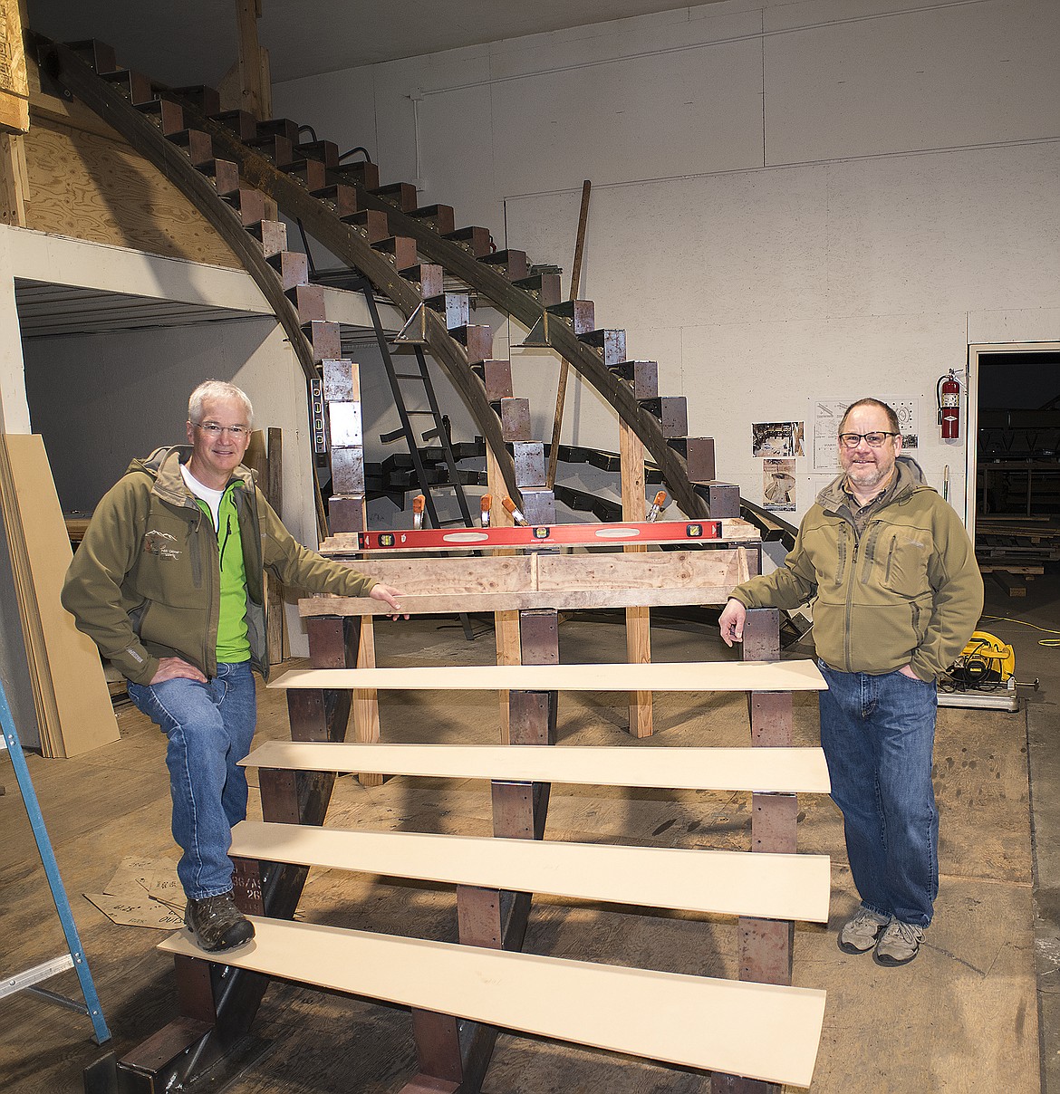 Tony Dawson, left, and John Hale with part of the new double helix staircase at their shop in Kalispell. The installation of the staircase is expected next month.