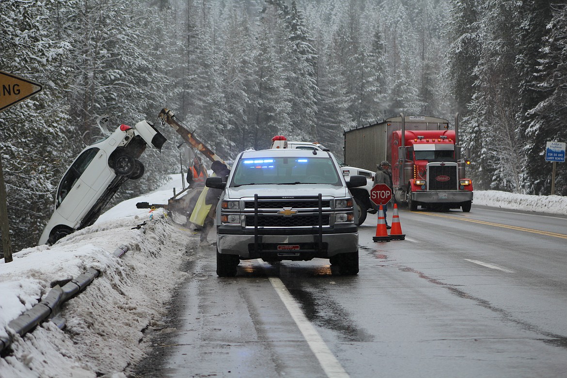 &#151;Photo by STAR SILVA
The Boundary County Sheriff&#146;s Office, Idaho State Police, and U.S. Border Patrol K-9 Unit, assist as Dyck&#146;s Towing pulls a vehicle up and over the southbound embankment on Peterson Hill, U.S. HWY 95, today. No fatalities reported. More information to follow in Thursday&#146;s edition of the Bonners Ferry Herald.