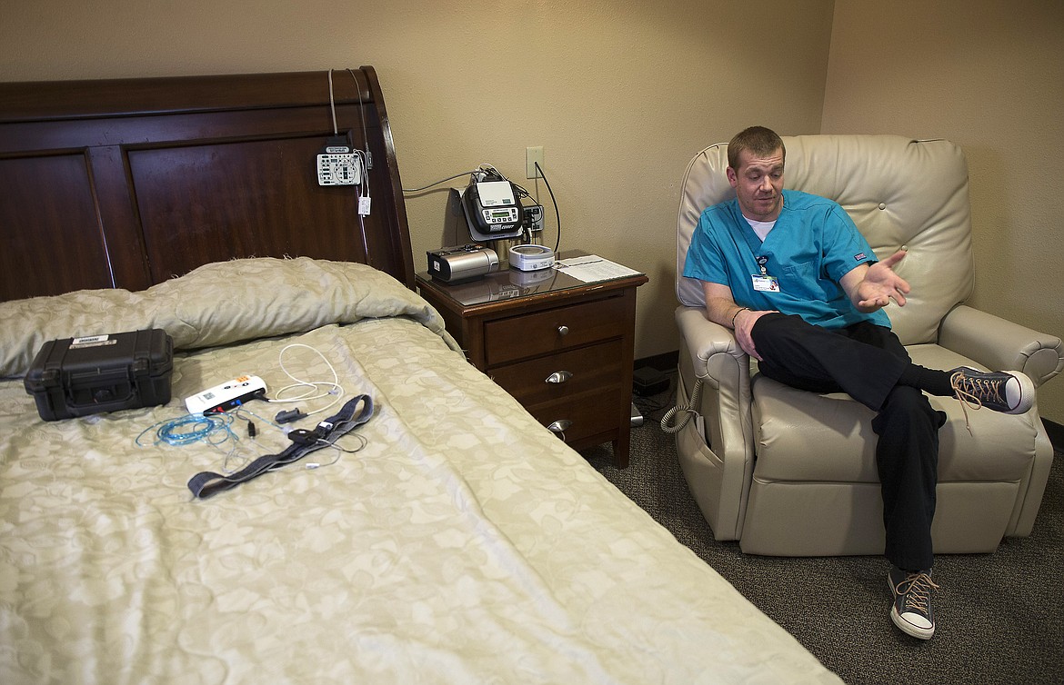 LISA JAMES/PressSitting in the Kootenai Health sleep lab on Friday, sleep technician Justin Weber explains the process and variables of testing for sleep apnea. Machines on the wall are for patients who come in for overnight testing, while the kit on the bed is a take home kit, which Weber says is more increasingly covered by insurance.