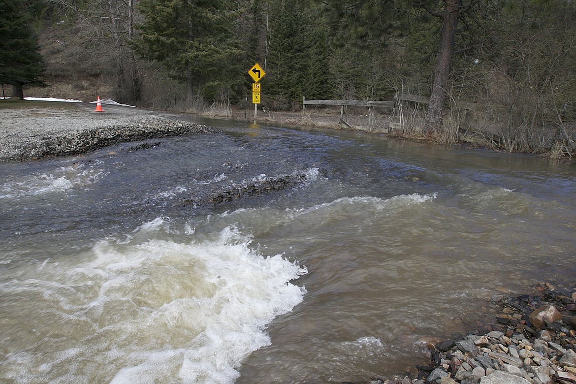 BRIAN WALKER/Press
Water flows over Reeva Lane off of Wolf Lodge Creek Road on Thursday.