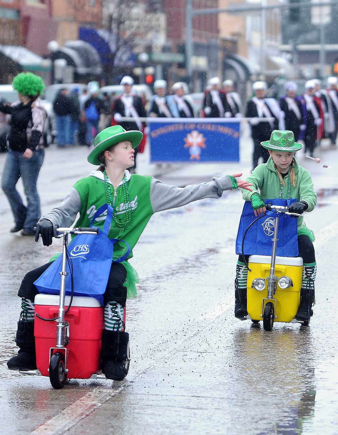 Beverly Hayes, left, throws candy to watchers along the parade route on Saturday, March 17, 2012, in Kalispell. In the background is Cadie Williams. The girls were both part of the Ancient Order of the Hibernians. (Brenda Ahearn/Daily Inter Lake)