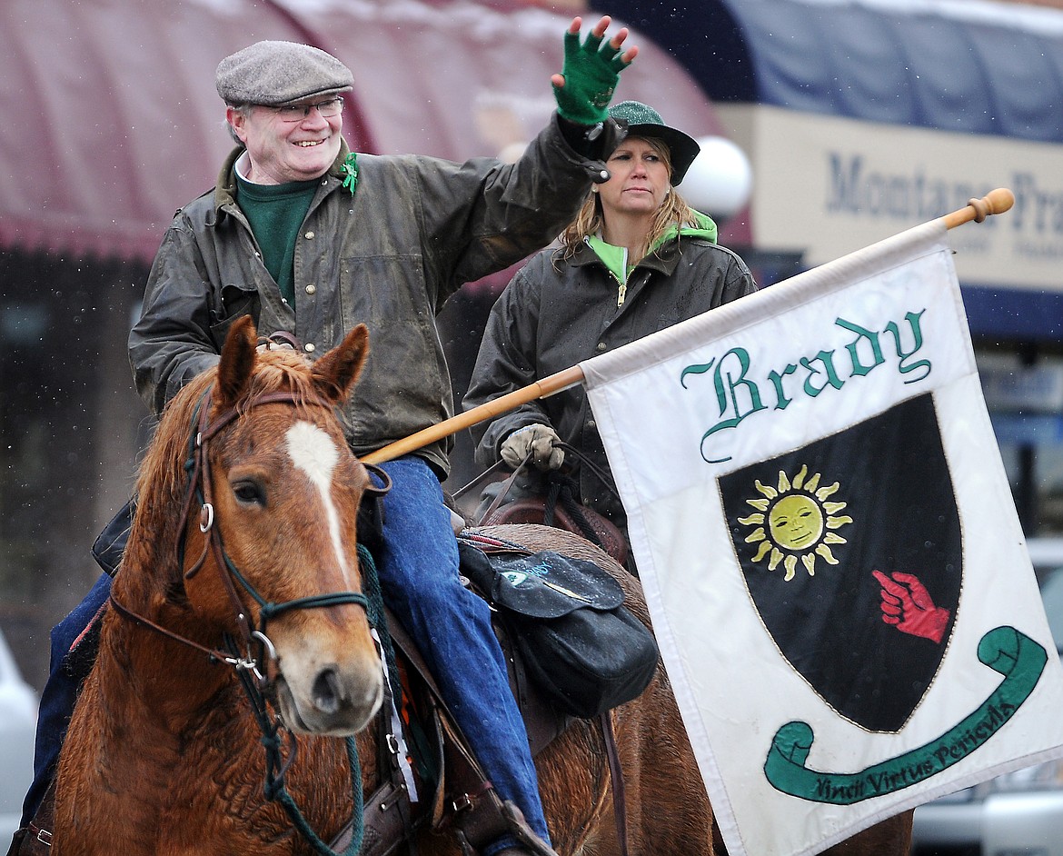 Dick Brady of the Ancient Order of the Hibernians waves to people lining Main Street for the annual St. Patrick&#146;s Day Parade in 2012 in downtown Kalispell. (Brenda Ahearn/This Week in the Flathead file photo)