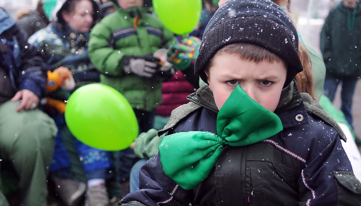 Cooper Vickhammer, 4, of Kalispell frowns at the snowy weather as he and others from the Child Development Center prepare for the start of the annual Saint Patrick&#146;s Day Parade on Saturday, March 17, 2012, in Kalispell. His mother referred to him as the grumpiest leprechaun of the day, but his mood improved immediately when he was given a cup of candy to throw to watchers along the parade route.
(Brenda Ahearn/Daily Inter Lake)