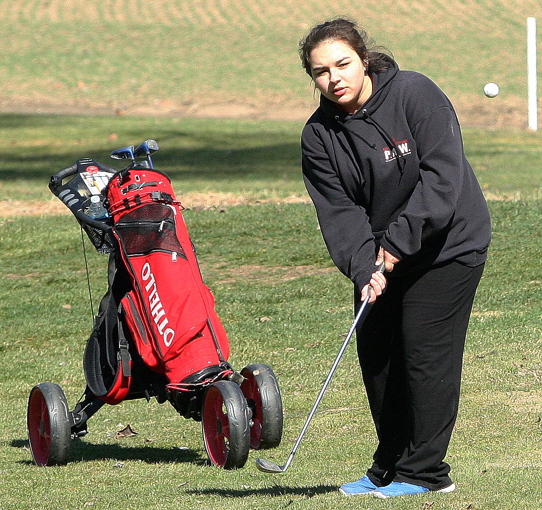 Rodney Harwood/Columbia Basin HeraldOthello's Candyss Miller chips on to the green on the 297-yard, par-4 10th hole during the Othello Invitational Thursday at the Othello Golf Club.