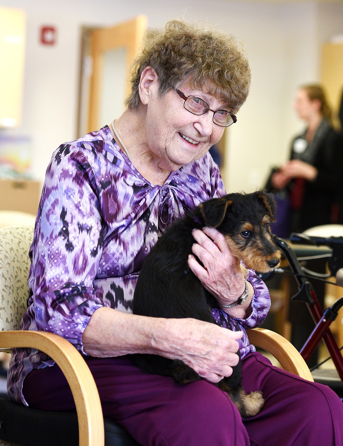 Joyce Siers holds an 8-week old Airedale terrier puppy at the Montana Veterans' Home in Columbia Falls on Wednesday. (Aaric Bryan/Daily Inter Lake)