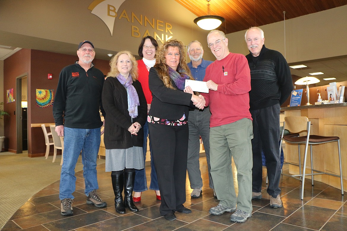 (Photo by CAROLINE LOBSINGER)
Banner Bank employees present a donation to representatives from Idaho Panhandle Habitat for Humanity. The group completed its 18th house in January with a dedication set for March 25; constuction on the group&#146;s nineteenth home will begin later this spring. Pictured in the back row, from left, are Dan Wimberly, Habitat for Humanity; Lisa Crider, Banner Bank; Teri Smith, Banner Bank; Tim Petersen, Habitat; and Cliff Lawrence, Habitat. Pictured in the front row are Teresa Nelson, Banner Bank branch manager; and Tom Harvil, president of Idaho Panhandle Habitat for Humanity.