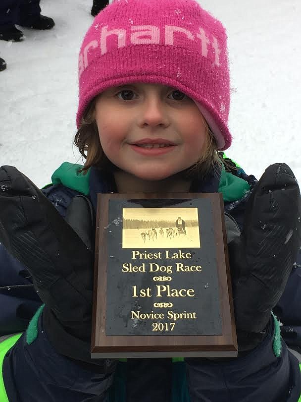Harleigh holds up her first place plaque from the Priest Lake sled dog race.
