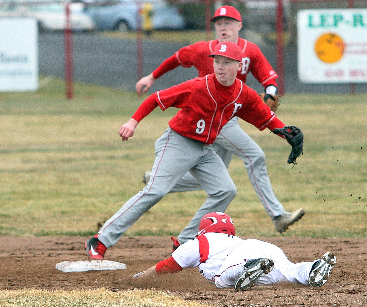 Rodney Harwood/The Sun Tribune - Othello base runner Gage Pruneda steals second base in first inning of the Huskies season opener against Bellingham.