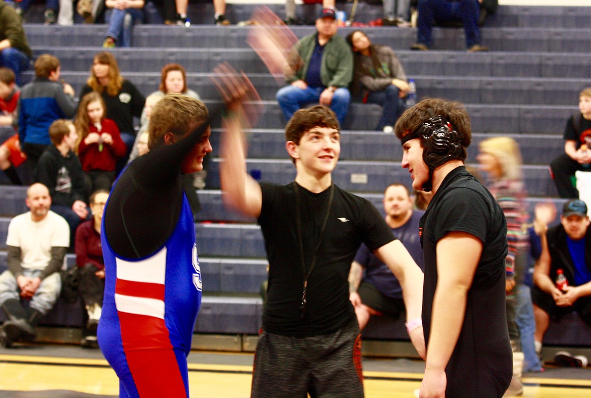 Tim Gallerneau from Superior has his arm raised to indicate he has won the match against Adam Aguillera from Plains/Hot Springs.