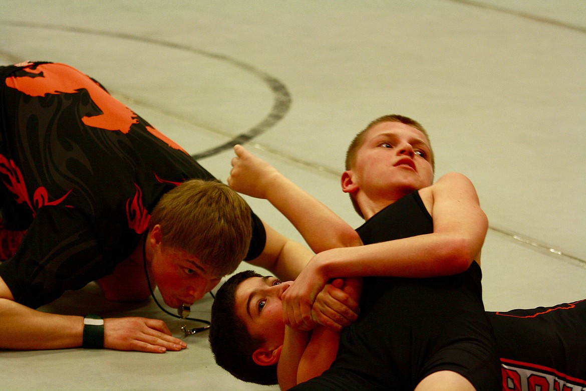 Brady Shrenk (from Plains, in all black) has James Kenelke (from Ronan) seconds away from an unofficial pin during the Wildhorse Little Guy Wrestling mixer in Plains.