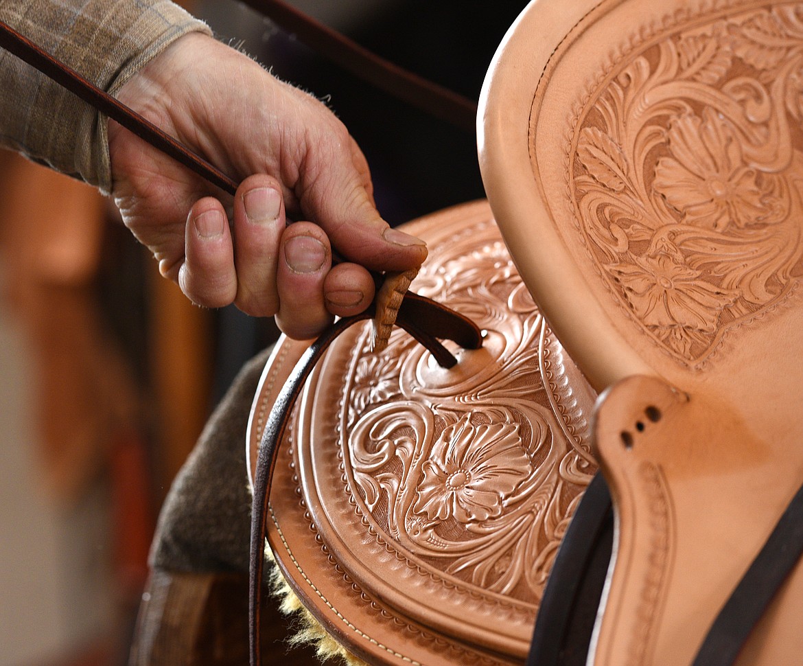 Jeff Morrow strings a rosette on the 3-B Visalia slick fork saddle.