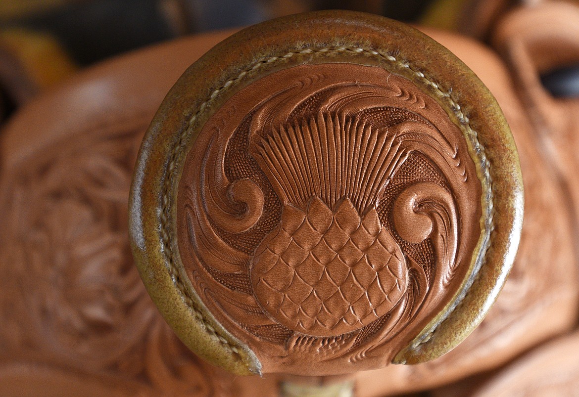 Jeff Morrow carved a Scottish thistle on the saddle horn for Dane Burns. All of Morrow's work is unique and customed to the individual. (Aaric Bryan/Daily Inter Lake)