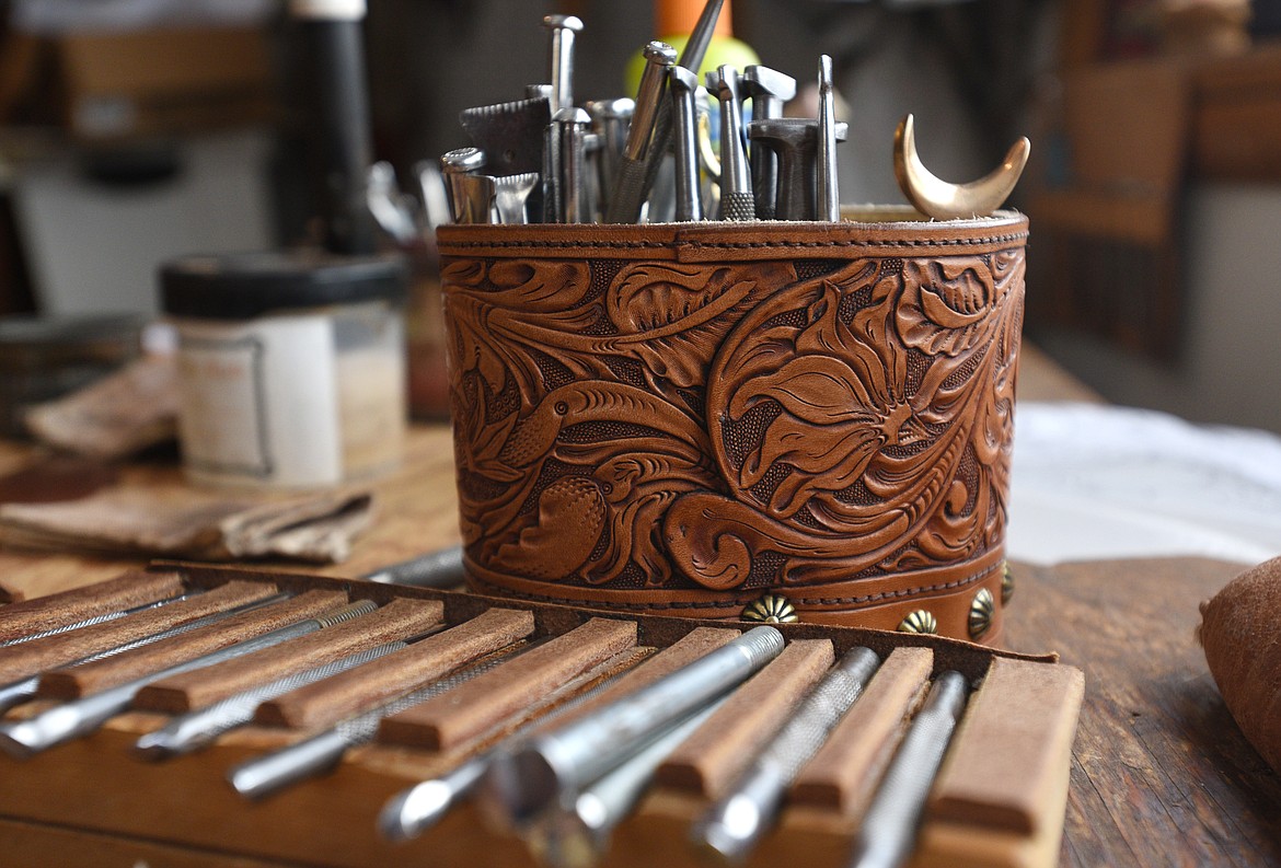 Stamps, swivel knifes and other tools fill a leather case on a workbench at Shooting Star Saddlery. (Aaric Bryan/Daily Inter Lake)