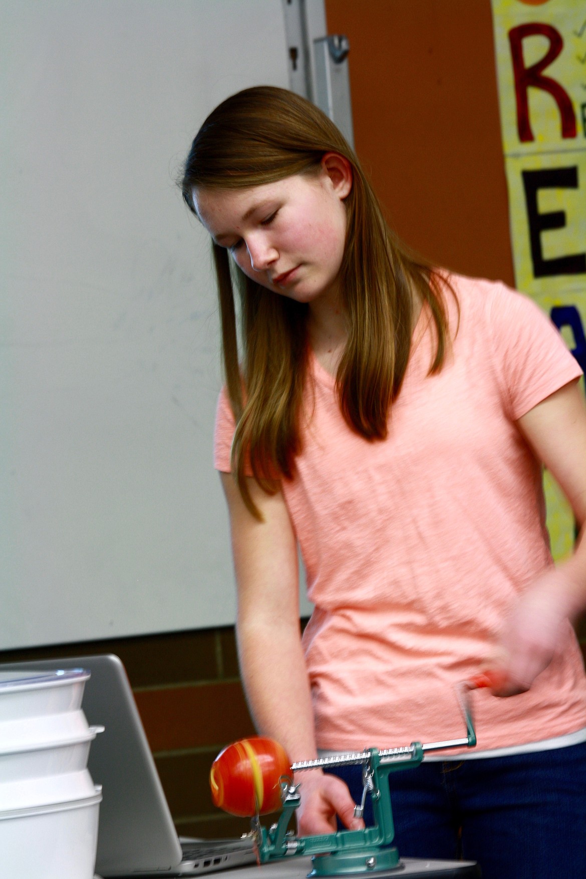 Skylar Bergstrom cores and slices an apple during her demostration on How to Make Dried Apples.