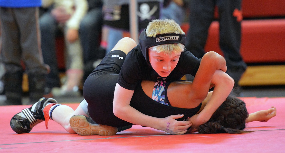 POLSON LITTLE guy wrestler Teague McElwee attempts to take down his opponent at the Little Guy Wrestling Tournament Saturday at Arlee High School. (Photo by Jason Blasco/Lake County Leader)