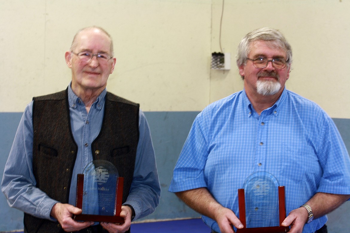 John Meckler and Stephen Welty stand with the awards they have been given for their nearly 50 years of combined service to the Plains fire and EMS services.