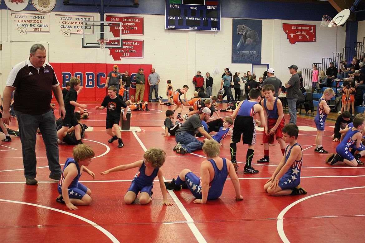 The wrestling beginners warm up for their afternoon tournament during Little Guy Wrestling in Superior, where six area teams matched up as beginners, novice and middle skill levels.