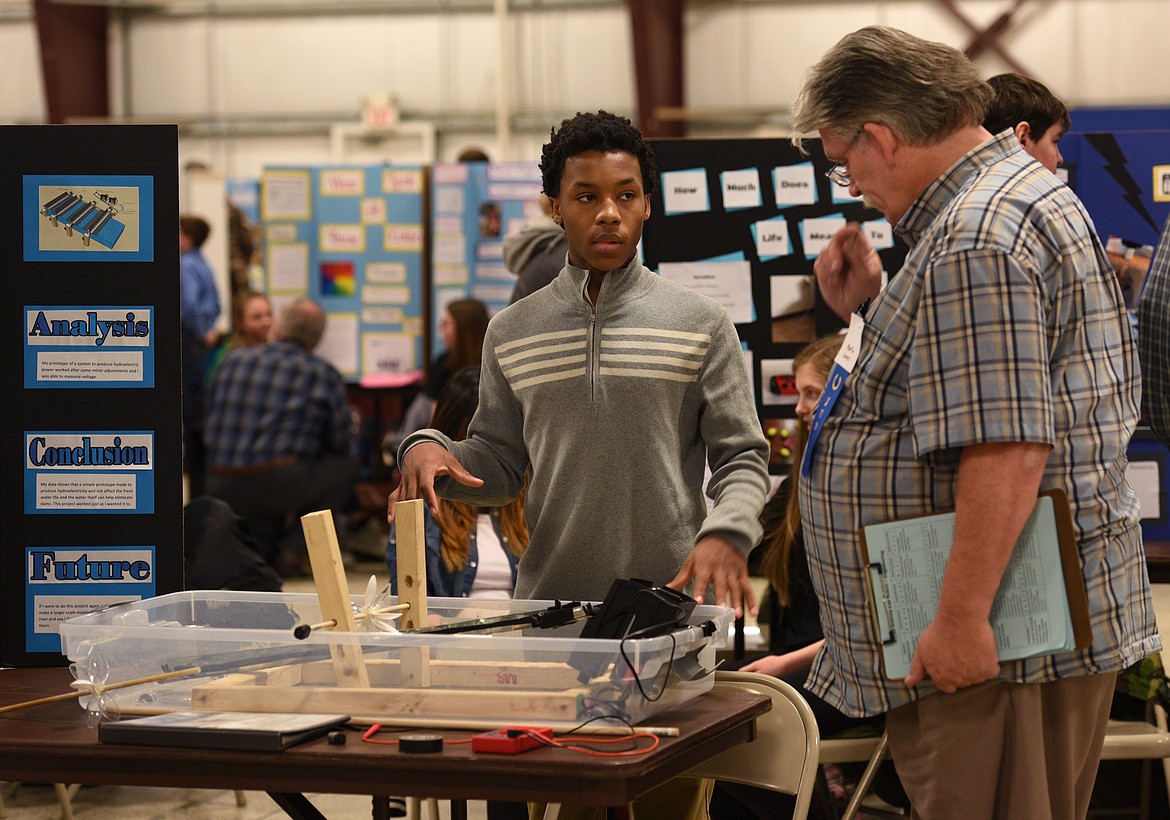 St. Matthew&#146;s School eighth-grader Jackson Barrett explains the water turbine he built to judge Martin Jones during the Flathead County Science Fair at the Flathead County Fairgrounds on Thursday. (Aaric Bryan photos/Daily Inter Lake)