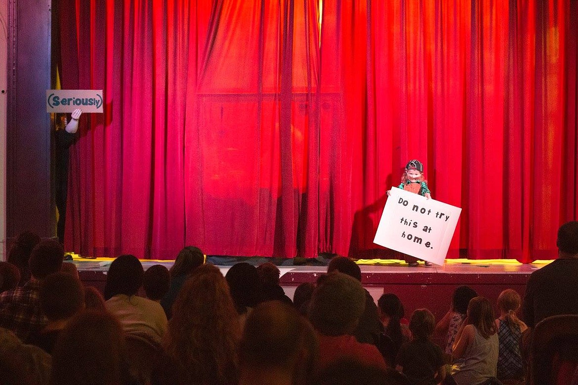 Preschooler McKayla Horn held a sign to introduce the next act as the set was put into place behind the big red curtin during the Variety Show on Feb. 25. (Photo by Brooke Barnett).