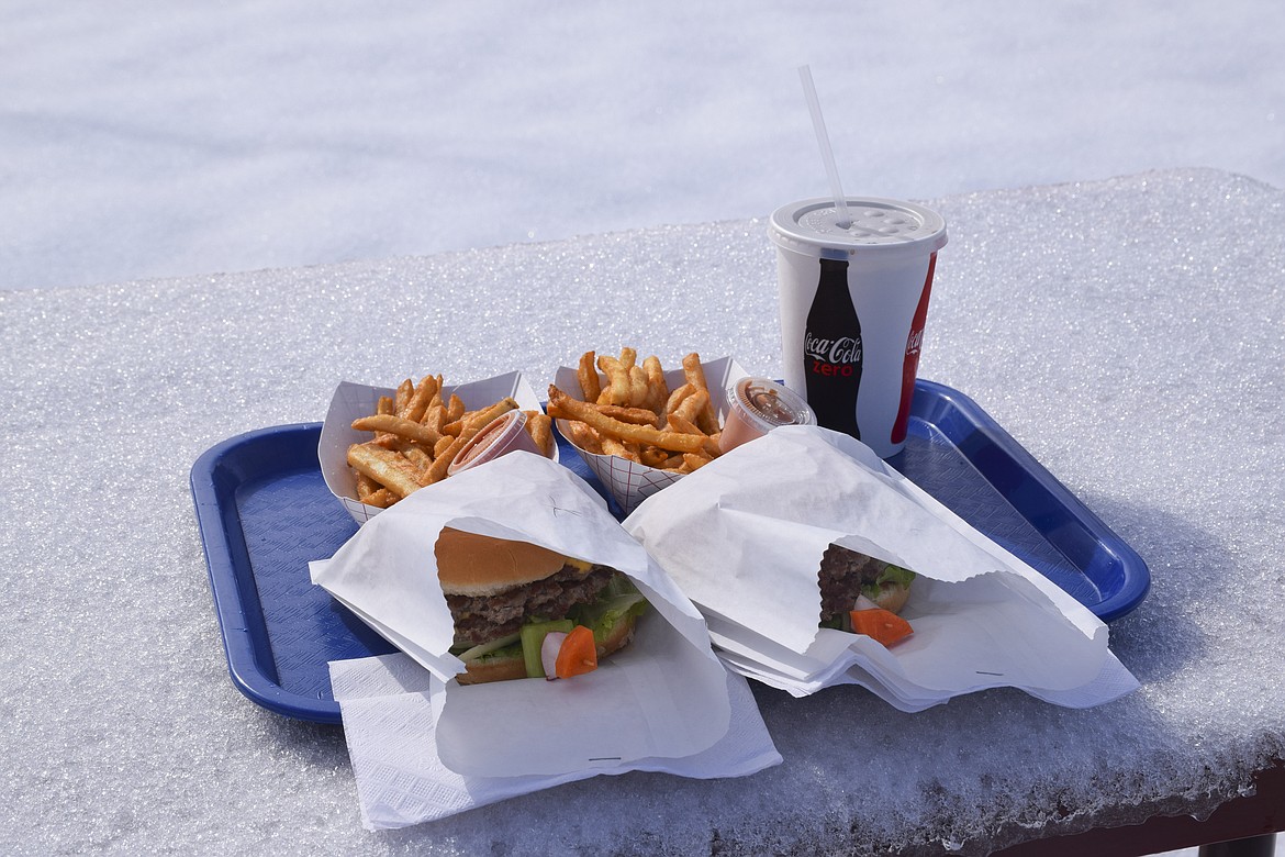 AN ORDER of Richwine&#146;s classic Royal Burgers is pictured on a snow-covered picnic table on Friday as the restaurant opened for its 55th season. (Brett Berntsen/Lake County Leader)