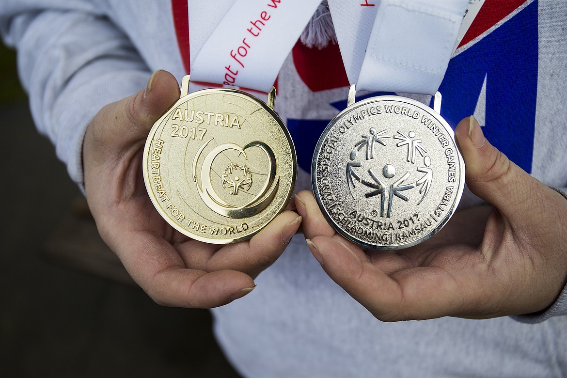 LOREN BENOIT/PressNathan Smalley holds his Special Olympics World Winter Games medals. Smalley went to Austria to compete in the advanced giant slalom, where he placed first, and the advanced slalom, where he placed second.  Smalley has been skiing with Special Olympics for over 15 years but this was the first time he competed at a global level.