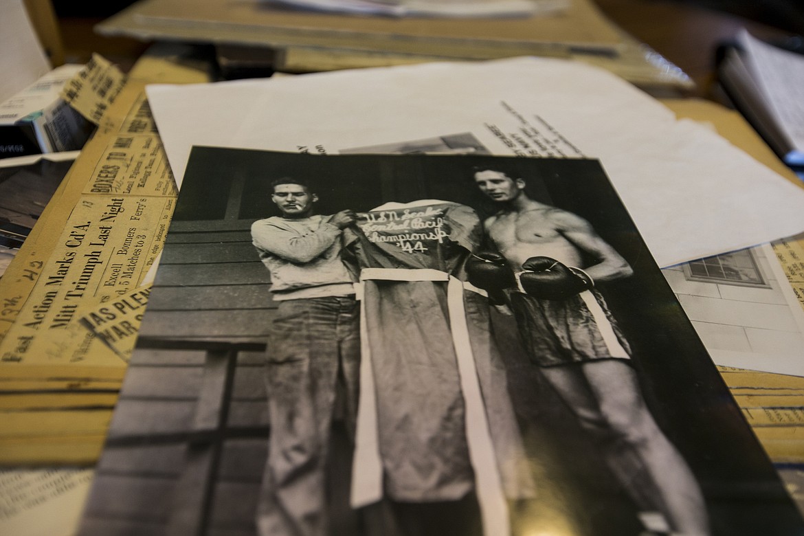 LOREN BENOIT/PressRobert &quot;Bob&quot; Eachon, right, holds his U.S. Navy Central Pacific Featherweight 1944 Championship robe.