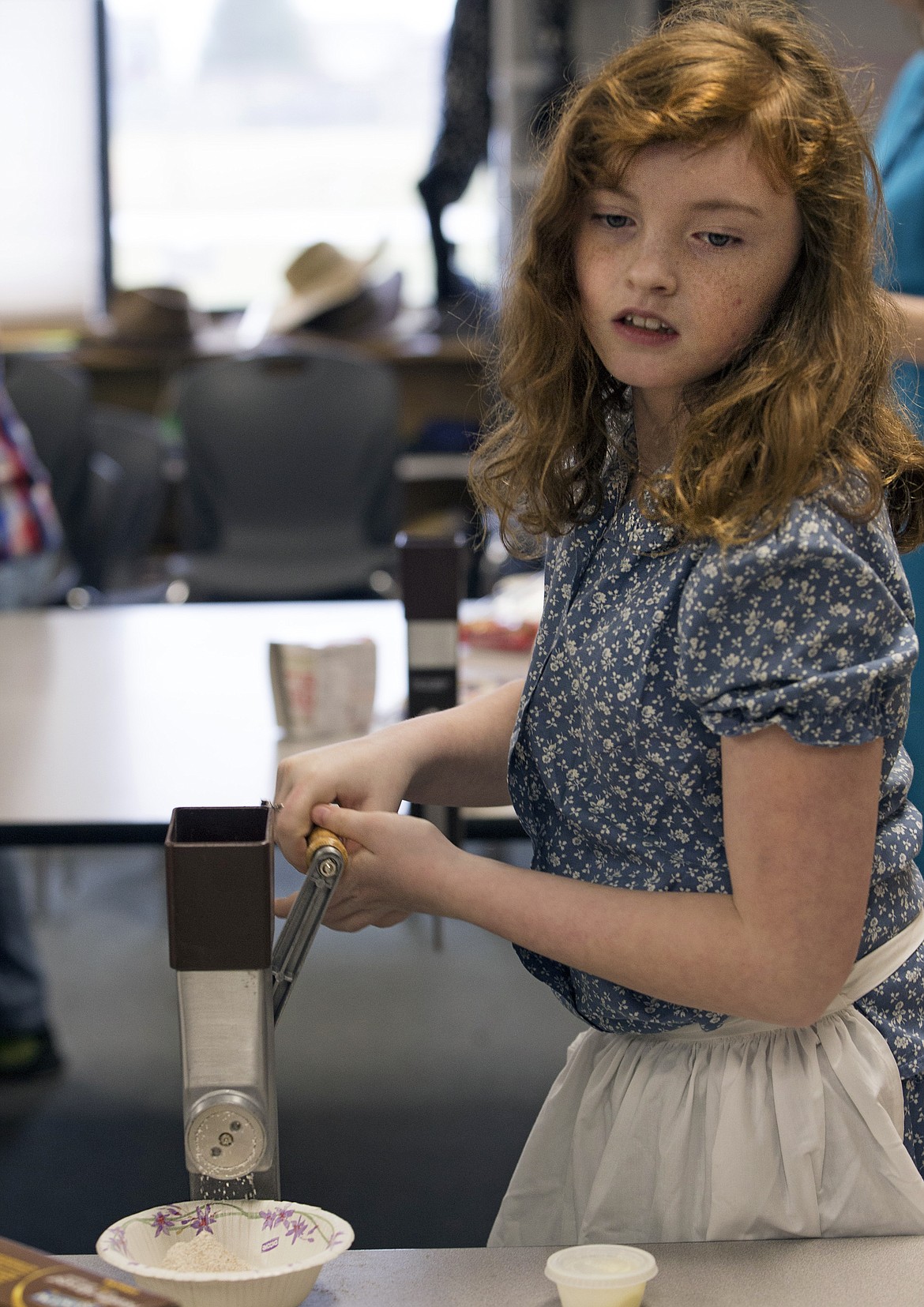 LISA JAMES/Press
Betty Kiefer Elementary School fourth-grader Charlotte Gomes grinds grains in an old-fashioned hand mill  on Friday.