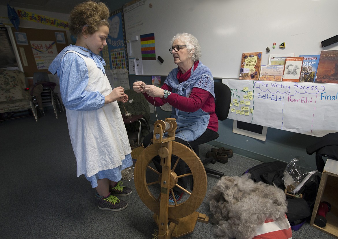 LISA JAMES/Press
Fiber artist Tina Ponzotti demonstrates how fiber is spun into yarn to make clothing to Betty Kiefer Elementary School fourth-grader Johnny Williams.