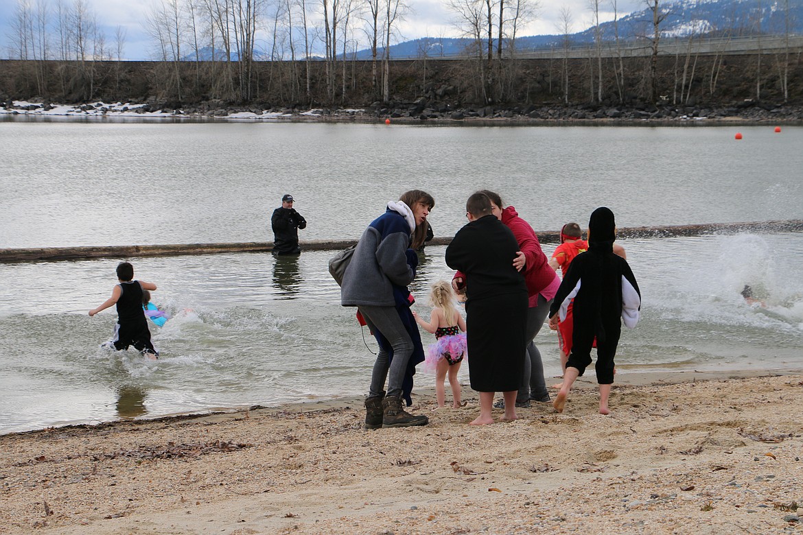 (Photo by MARY MALONE)
Community members of all ages braved the chilly lake water Saturday at City Beach during the annual Penguin Plunge event to benefit the Special Olympics.