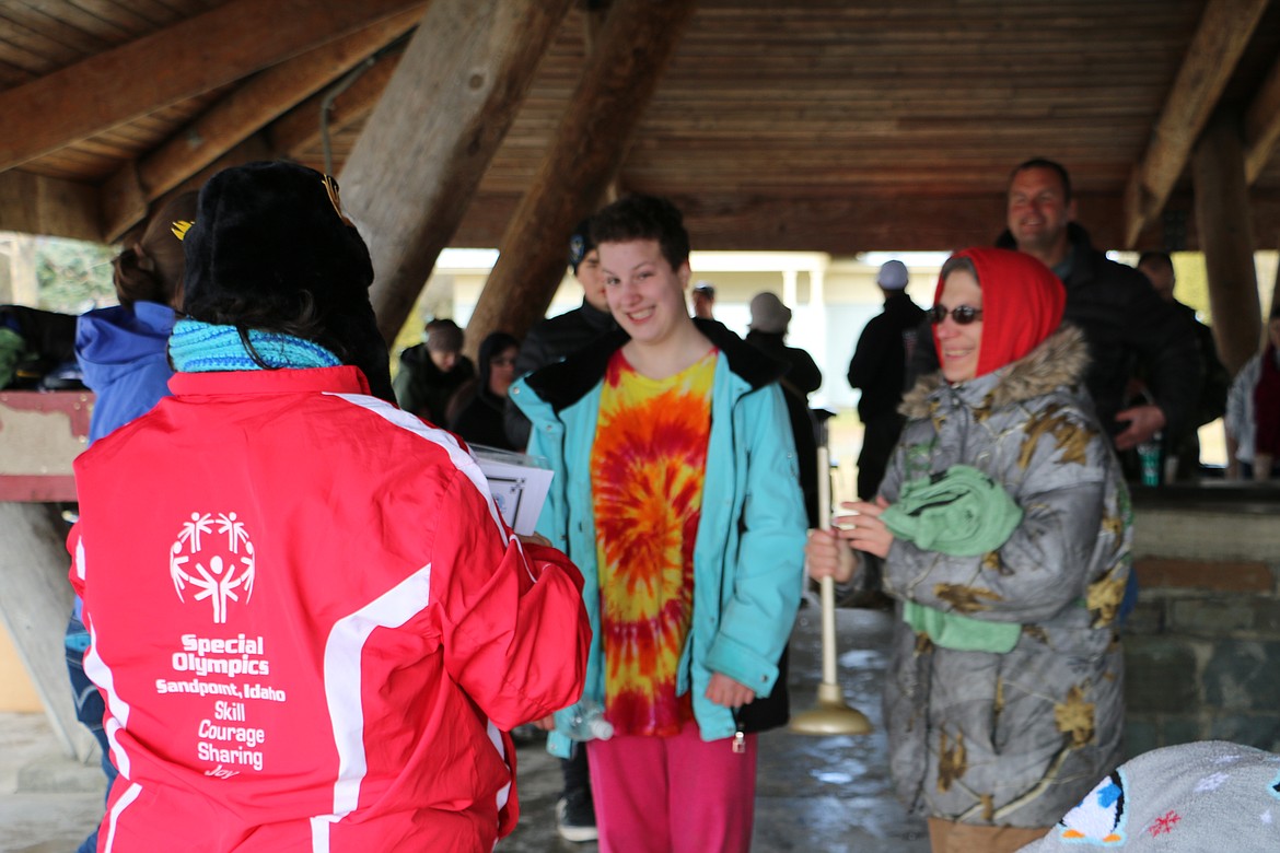 (Photo by MARY MALONE)
Sandpoint Special Olympian Santana Martin, center, won the golden plunger trophy Saturday during the annual Penguin Plunge fundraiser at City Beach benefiting the Special Olympics.