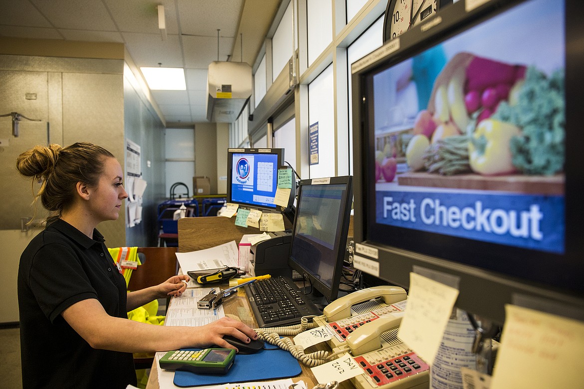 LOREN BENOIT/Press

Fred Meyer employee Ashlee Thompson keeps track of ClickList grocery lists as they come in Wednesday afternoon. More than 40 orders on average are placed each day through ClickList.