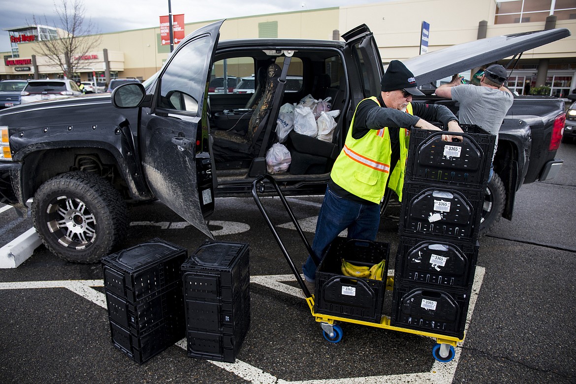 LOREN BENOIT/PressFred Meyer employee Manny Tavison helps Andy Ost with his ClickList groceries Wednesday morning. Customers first go online and select items and then pick a one hour window to pickup their groceries at reserved ClickList parking spaces.