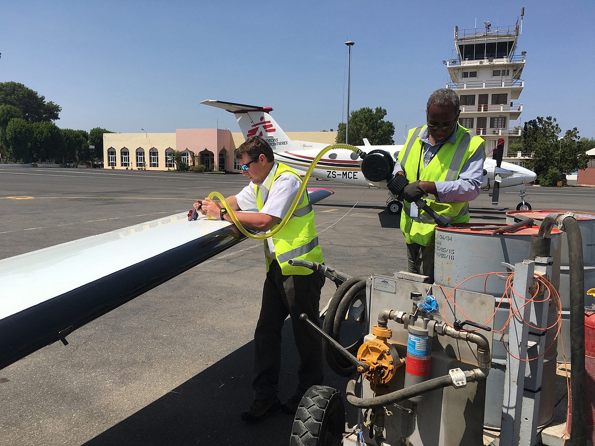 Chris Johnson uses a hand pump to fuel the plane with Avgas (aviation fuel) in Djibouti.