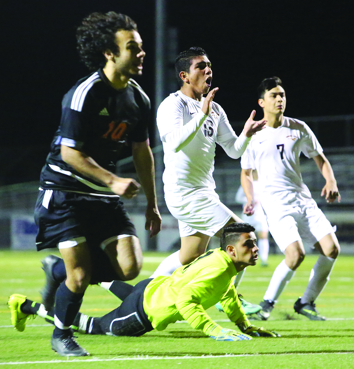 Connor Vanderweyst/Columbia Basin Herald
Moses Lake's Erik Vega (center) reacts to scoring in the second half against Davis.