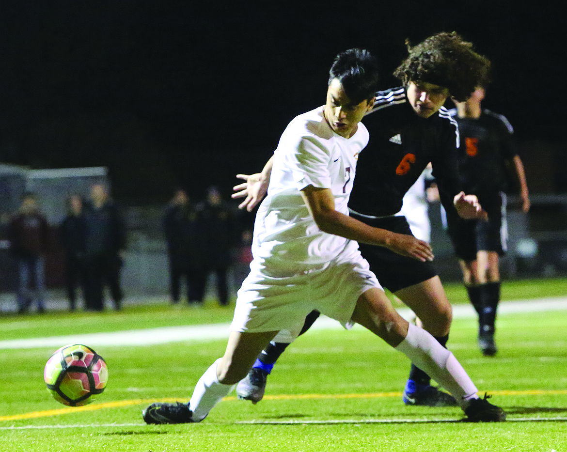 Connor Vanderweyst/Columbia Basin Herald
Moses Lake forward Anthony Cortez tries to control the ball in front of Davis defender Alejandro Borges.