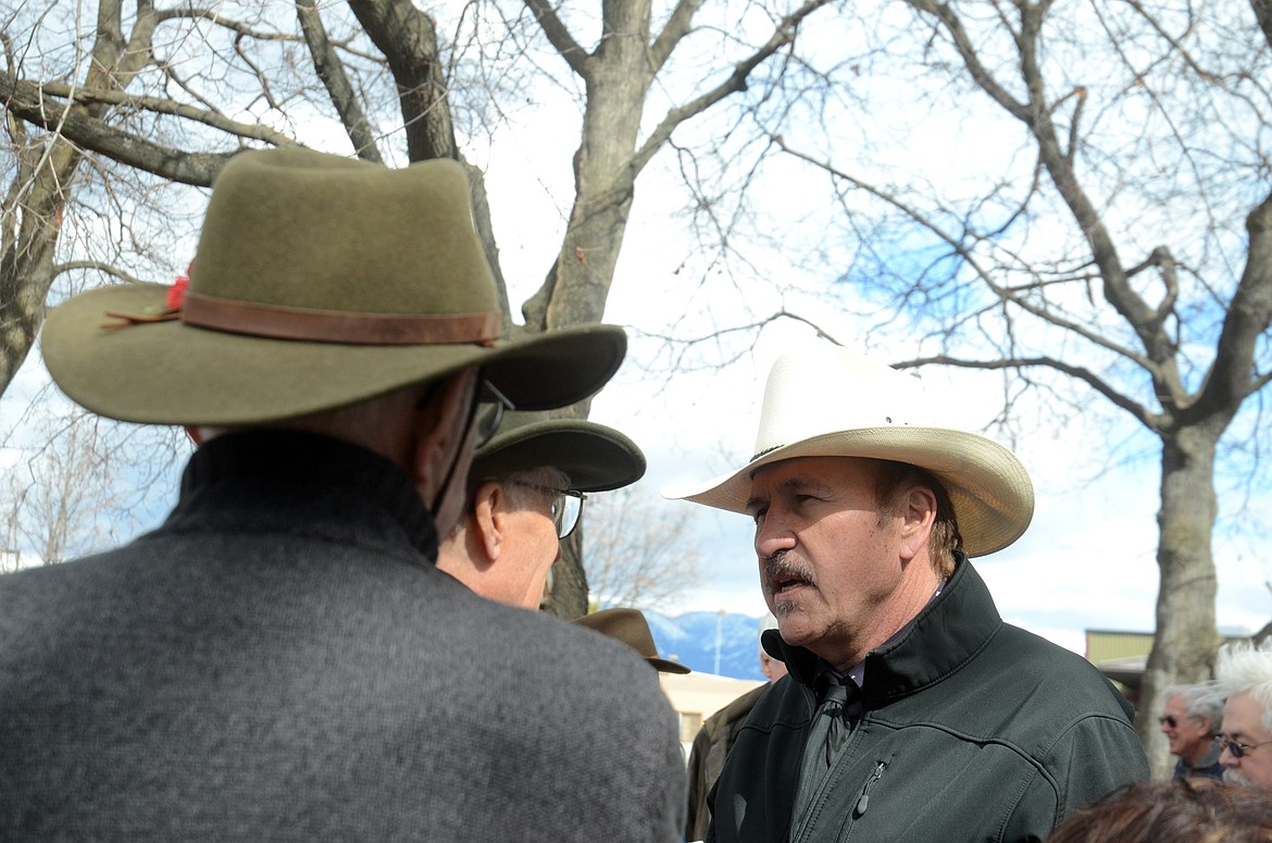 Rob Quist, right, Democratic candidate for Montana&#146;s U.S. House seat, visits with attendees at a public lands rally Saturday at Depot Park in Kalispell.