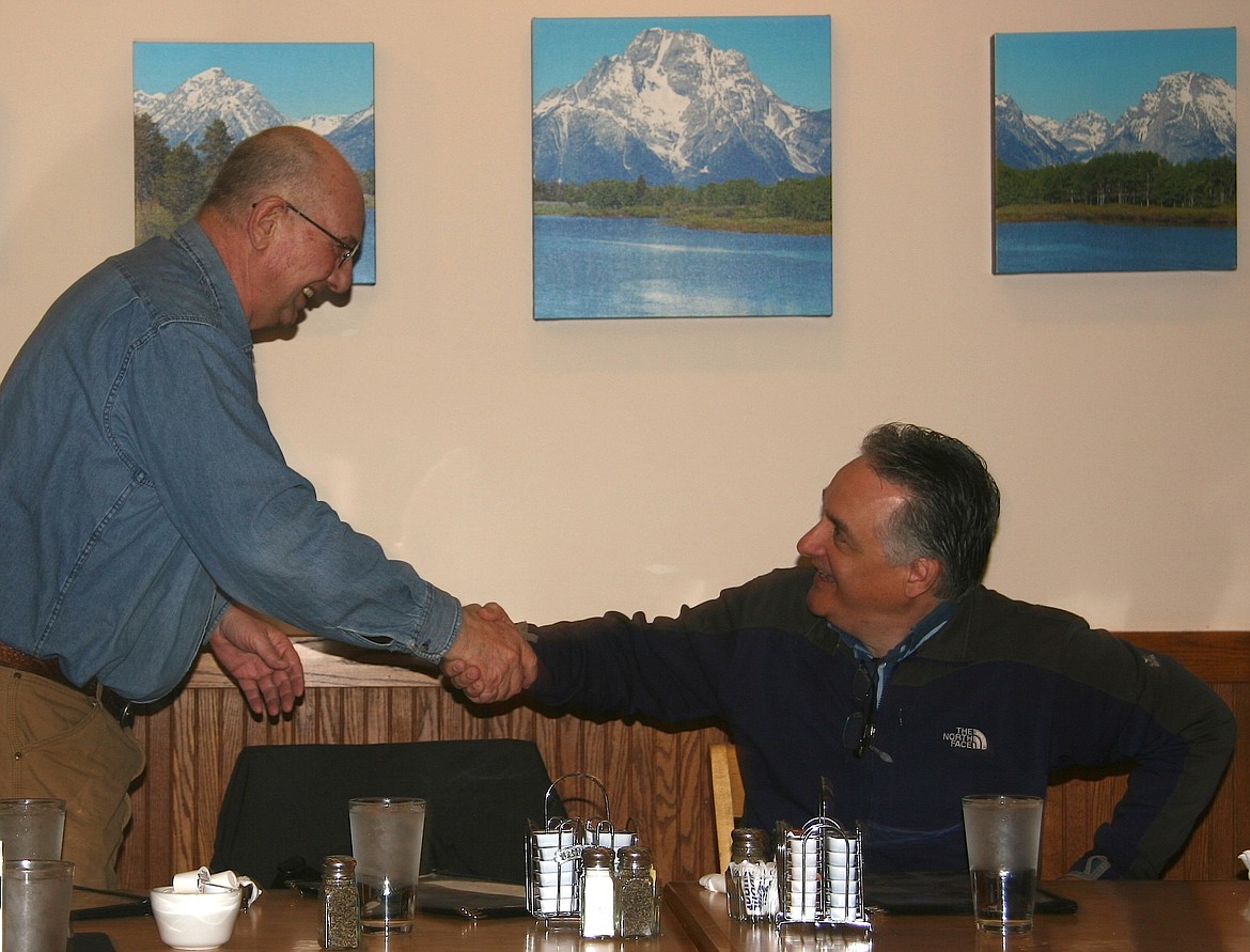 BRIAN WALKER/Press
Bob Tester, right, who served in multiple leadership positions in the Air Force and a member of the Of Cabbages and Kings breakfast club, greets Coeur d'Alene Mayor Steve Widmyer to the gathering on Wednesday at Elmer's.