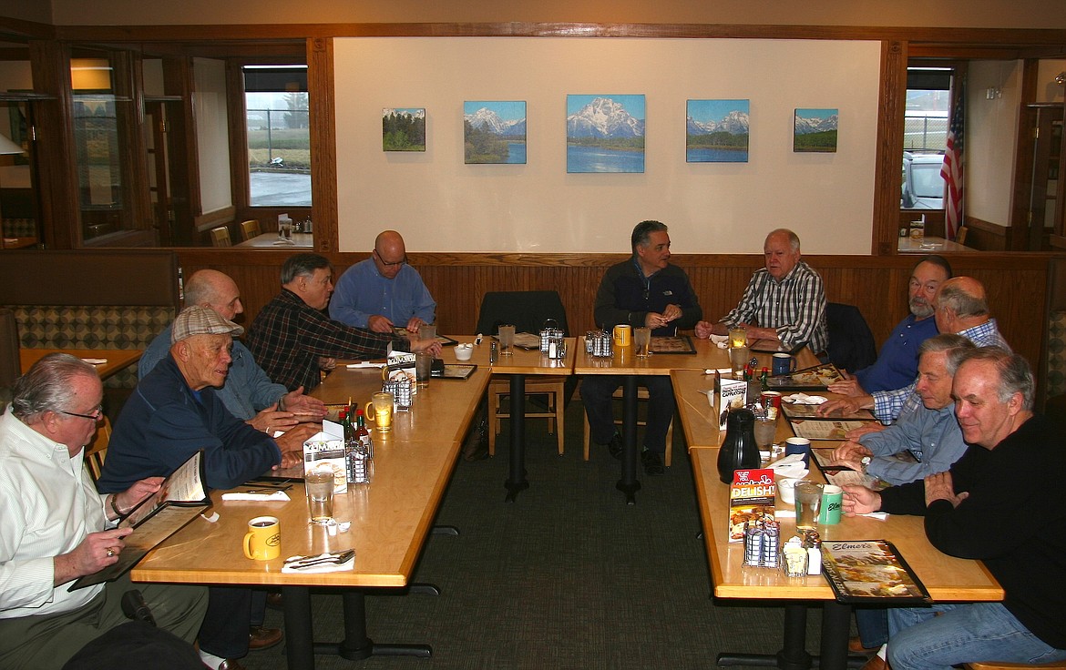 BRIAN WALKER/Press
Coeur d'Alene Mayor Steve Widmyer, back center, took the hot seat during the Of Cabbages and Kings breakfast club gathering at Elmer's on Wednesday.