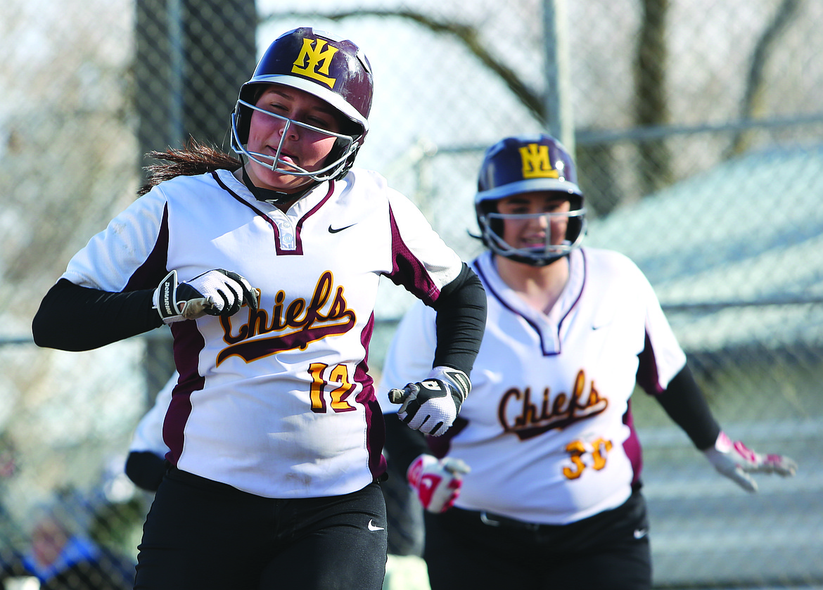 Connor Vanderweyst/Columbia Basin Herald
Brooke Richardson (left) and Paige Valdez head into the dugout after scoring in the second inning.