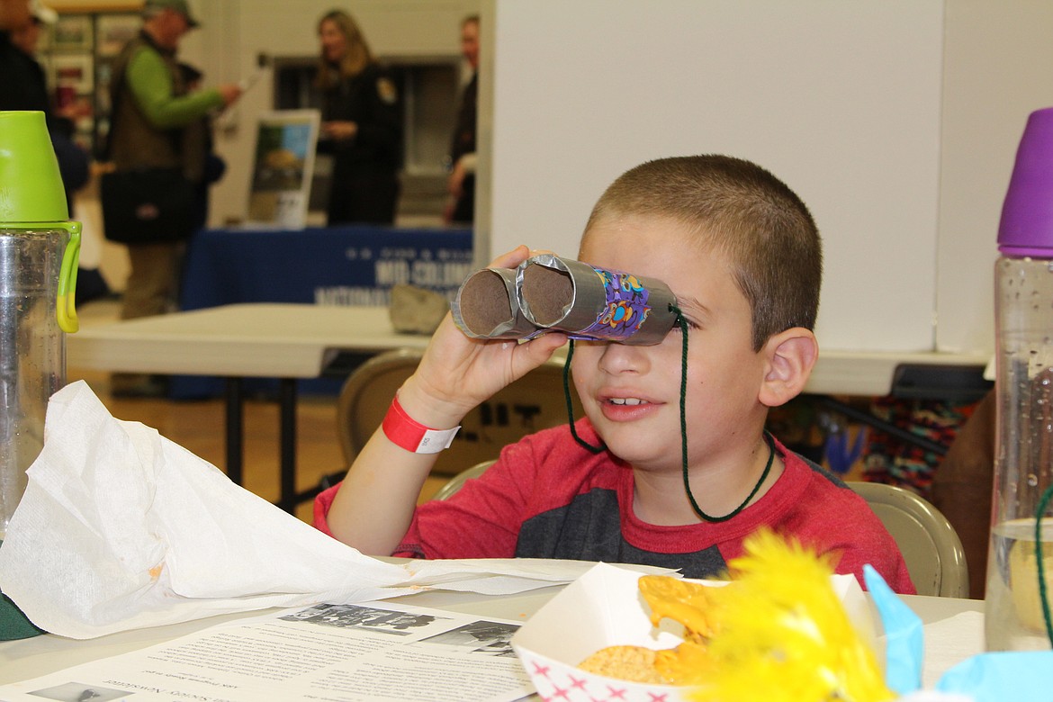 Cheryl Schweizer/Columbia Basin Herald
A birdwatcher in training checks out his &#145;binoculars&#146; at the Sandhill Crane Festival Saturday in Othello.