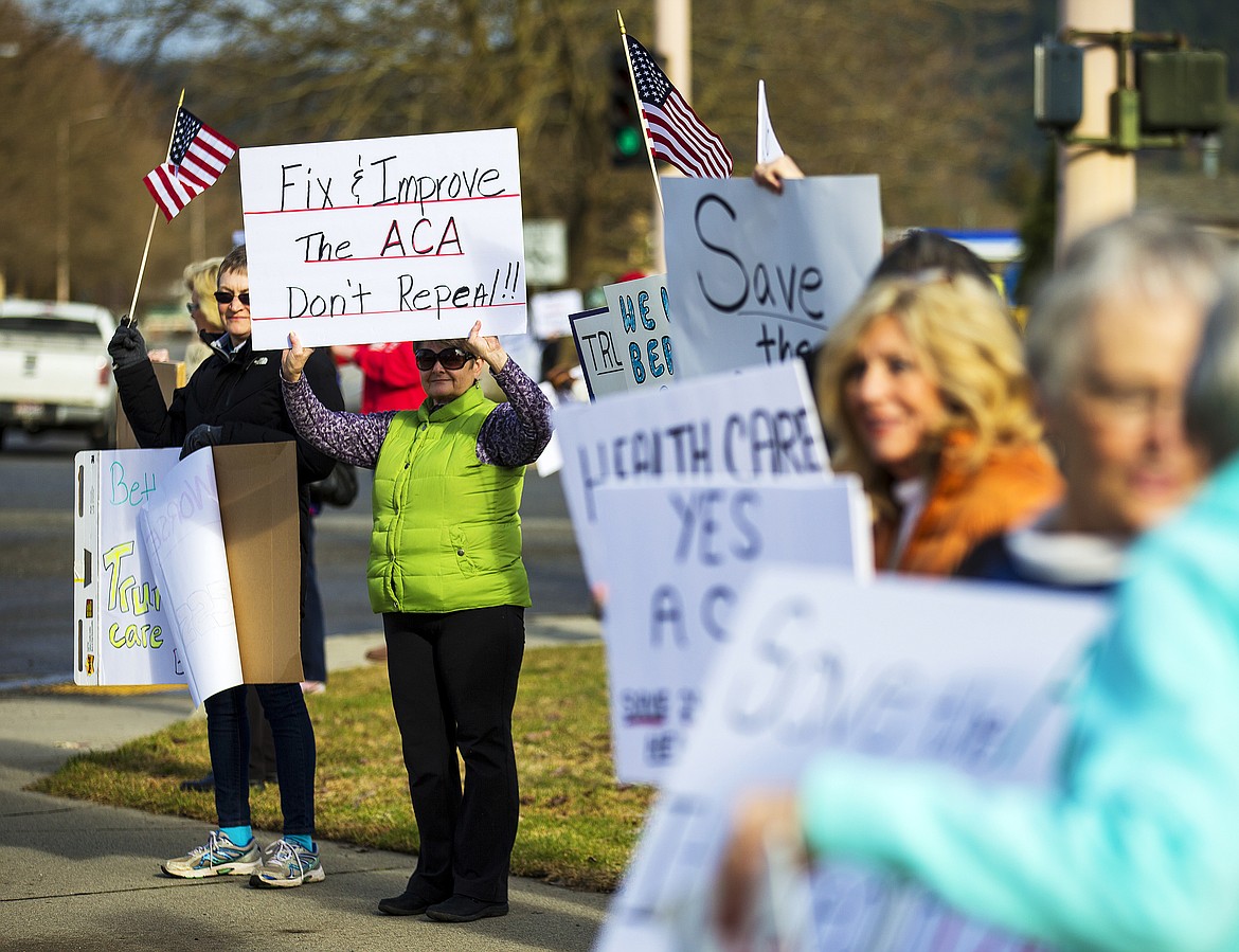 LOREN BENOIT/PressGayla Moseley, in green, stands with fellow Indivisible North Idaho activists near Kootenai Health Tuesday evening. Republican leaders plan a vote Thursday for whether to keep or repeal Obamacare.