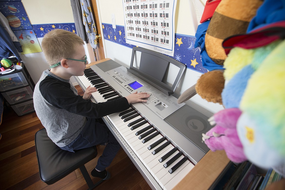 LISA JAMES/Press
Brady Schroeder, 9, plays his piano in his Coeur d'Alene home.