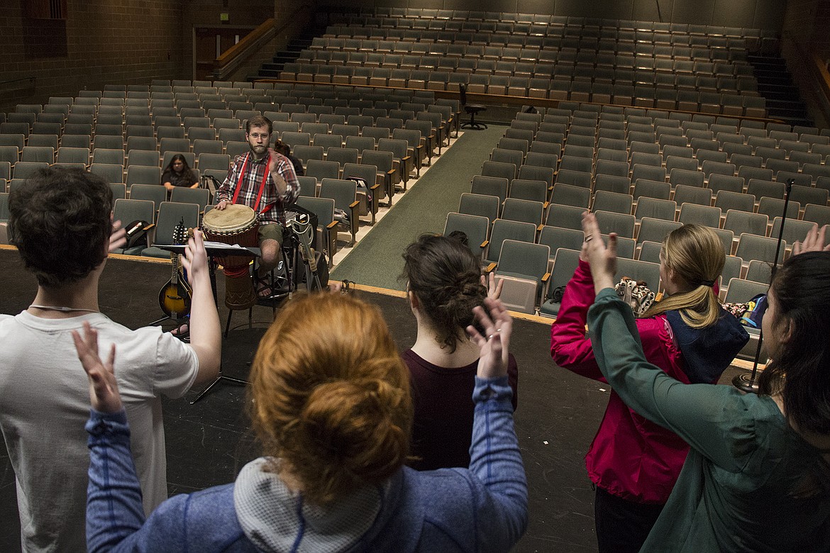 BETHANY BLITZ/PressLake City High School choir teacher, Mark Petty, plays the drum while his Mixed Choir class rehearses the South African song &#147;Singabahambayo&#148; in class Tuesday before their concert that night. All the choir classes have been studying songs from various Native American tribes and foreign countries.