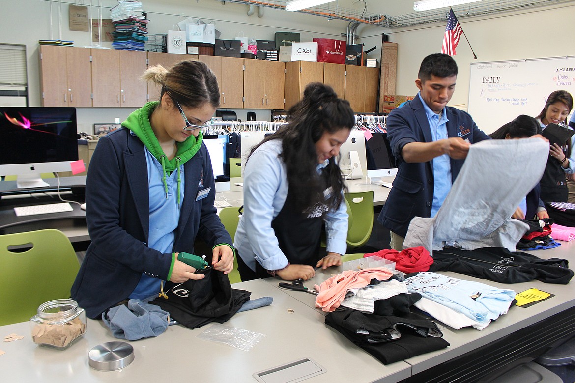 Cheryl Schweizer/Columbia Basin Herald
Students in the CB Tech entrepreneur and marketing class price, sort and fold clothes for the new Pipes and Pallets boutique, opening Tuesday.